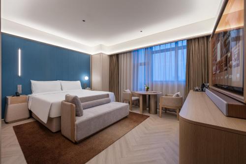 Postel nebo postele na pokoji v ubytování Orange Crystal Hotel Nanjing Jiangning Sasseur Southeast University