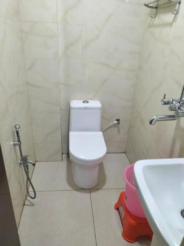 a bathroom with a toilet and a sink at Hotel Temple View in Bodh Gaya