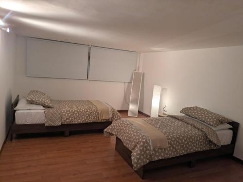 a room with two beds in a room at Domus Battisti in Caserta