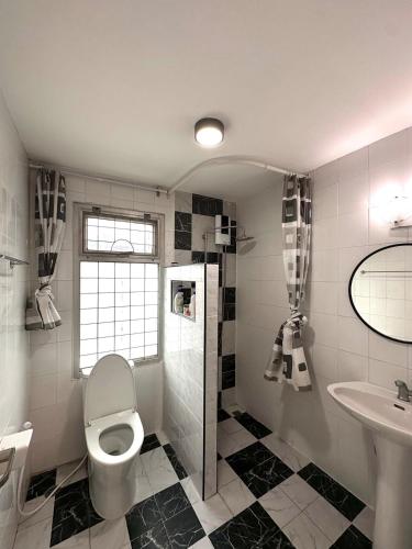 a bathroom with a toilet and a sink at Cozy Stay in Ban Nong Waeng