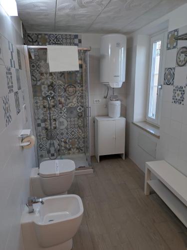 a bathroom with a toilet and a sink at Domus Battisti in Caserta