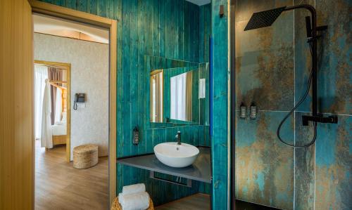 a bathroom with a sink and a shower with a mirror at Tresort Oil Glamping in Principina Terra