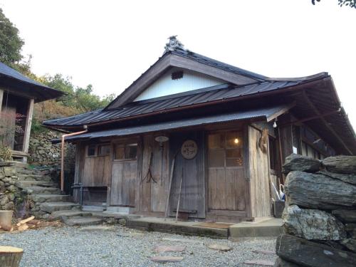 a small wooden house with a large door at Oyamanoyado Michitsuji in Otoyocho