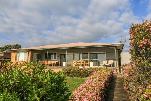 a house with a garden in front of it at Bunkys By The Sea Holiday House in Berrara