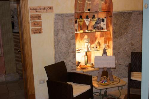 a room with a chair and a table with a laptop at Villa Cosilinum in Padula