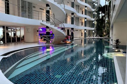 a swimming pool in the middle of a building at Sunset Plaza Condominium in Karon Beach