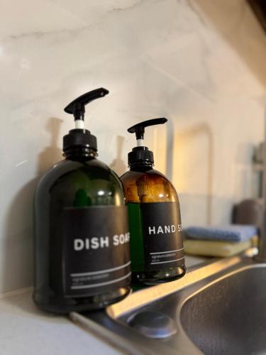 two bottles of dish soap sitting on top of a sink at Eden Living - Cebu in Lapu Lapu City