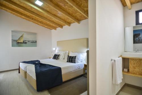 En eller flere senge i et værelse på Encosta Azul