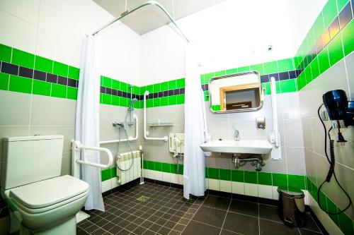 a bathroom with a toilet, sink, and shower stall at Restart in Rēzekne