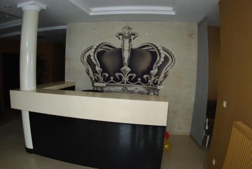 a crown on a wall in a room at Hotel Pod Złotą Koroną in Opole