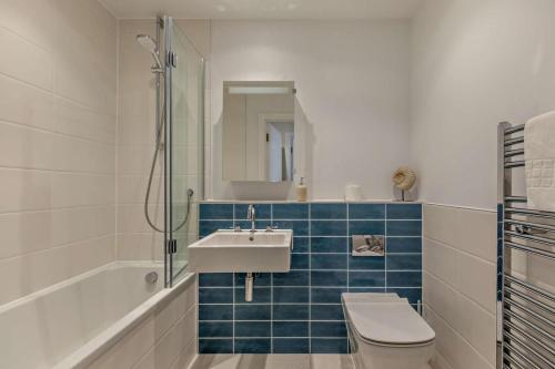 a bathroom with a sink and a toilet and a shower at 2 Bed in Woolacombe oc-s29622 in Woolacombe