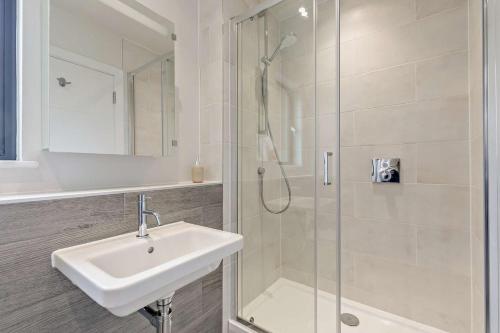 a white bathroom with a sink and a shower at 2 Bed in Woolacombe oc-s29469 in Woolacombe