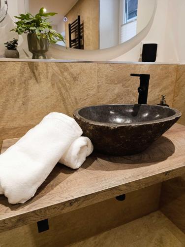 a bathroom with a black bowl sink on a counter at Bergstadthaus Sankt Andreasberg für Familien und Freunde in Sankt Andreasberg