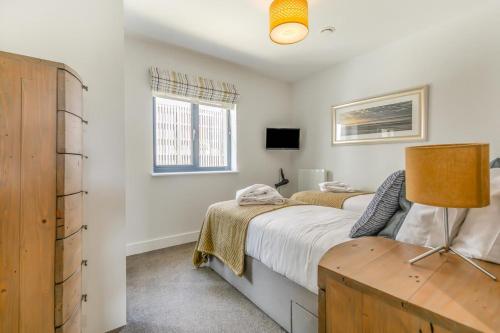a bedroom with a bed and a desk and a window at 3 Bed in Woolacombe oc-t29466 in Woolacombe
