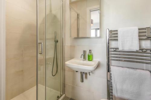 a bathroom with a glass shower and a sink at 3 Bed in Woolacombe oc-t29466 in Woolacombe