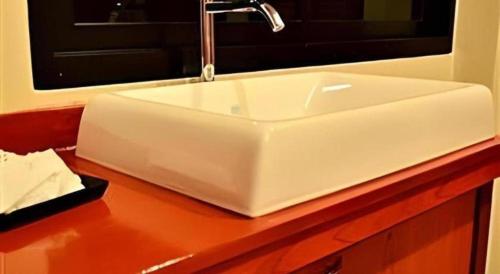 ein weißes Waschbecken auf einer Theke in der Unterkunft Kwan Phayao Villa in Phayao