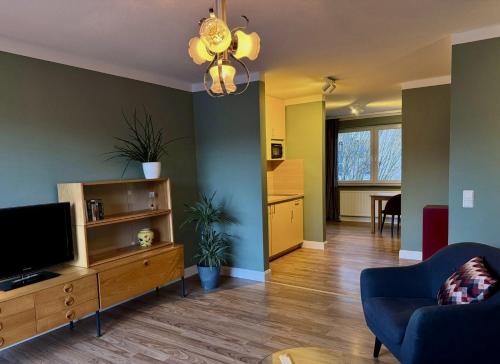 a living room with a flat screen tv and a couch at Appartement Werft & Meer in Lauterbach