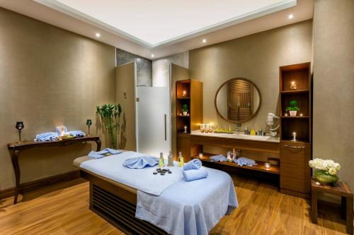 a spa room with a bed and a mirror at Grannos Thermal Hotel & Convention Center in Haymana