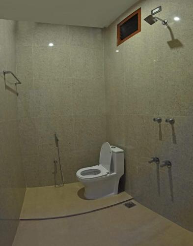 a bathroom with a toilet and a shower at Sivakumar paradise in Mahabalipuram