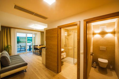 a bathroom with a shower and a chair and a table at Gut Leithaberg in Jois