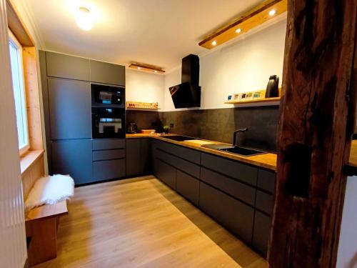 a kitchen with a sink and a stove top oven at Harzer Bergstadthaus für Familien und Freunde in Sankt Andreasberg
