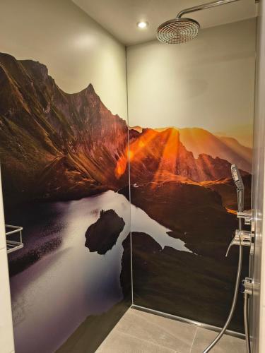 a shower in a bathroom with a painting on the wall at Gästehaus Finkel in Maderhalm