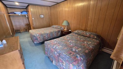 een hotelkamer met twee bedden en een tafel bij Black Cat Guest Ranch in Brule Mines