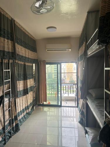 a room with a hallway with a door to a balcony at OST Homes Rolla Park in Sharjah