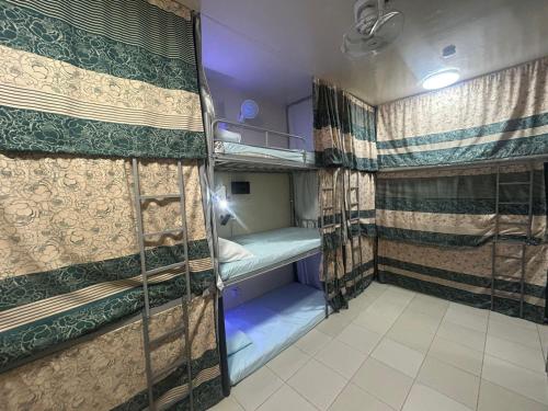 a couple of bunk beds in a room at OST Homes Rolla Park in Sharjah
