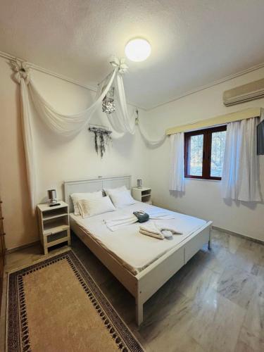 a bedroom with a large white bed in a room at Mani Beach House in Vathia