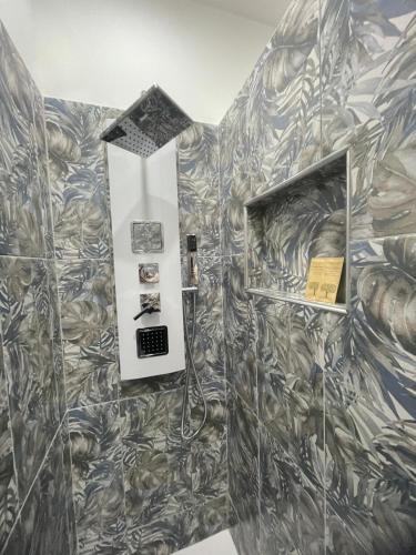 a bathroom with ailed wall with a mirror at Loft Home Sweet Home in Catania
