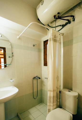 a bathroom with a toilet and a sink and a shower at Studios ΕΥΤΥΧΙΑ-6 in Kalavrita