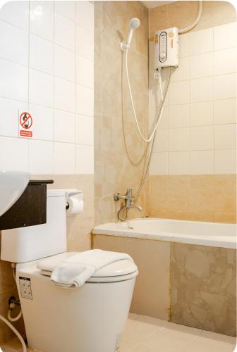 a bathroom with a toilet and a bath tub at The Star House in Patong Beach