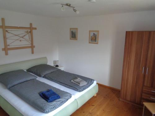 una camera da letto con un letto e un armadio in legno di Urlaubsoase-Lindenhof a Pfaffendorf