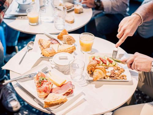 a group of people sitting around a table eating food at Tribe Carcassonne in Carcassonne