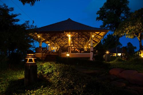 a gazebo lit up at night with lights at Sabaidee Valley in Ban Gnik