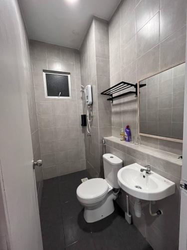 a bathroom with a toilet and a sink at Adelia SweetHome in Kajang