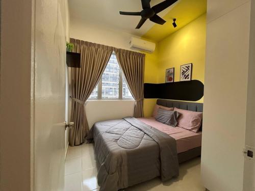 a bedroom with a bed and a ceiling fan at Adelia SweetHome in Kajang