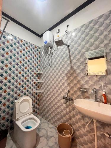 a bathroom with a toilet and a sink at Captains cabin in Tikri Kalān