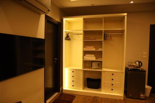 a room with a closet with white shelves at Munir`s residence 2 in Cairo