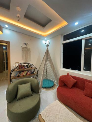 a living room with a couch and a hammock at Simbas Den by Abodeandco in Dehradun