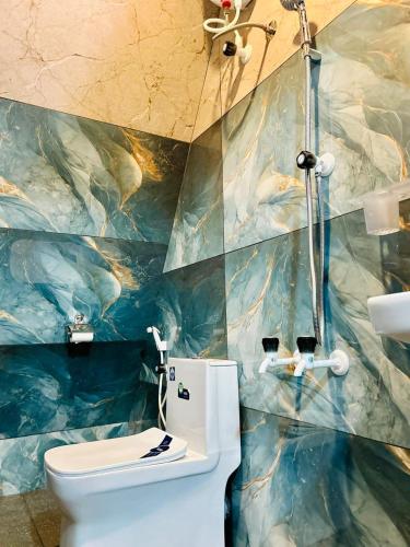 a bathroom with a toilet and a shower at Greene Villa in Palakkad