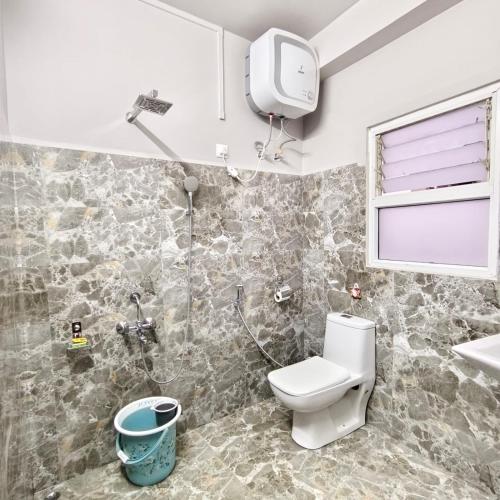a bathroom with a toilet and a shower at Hotel ODC Residency in Jowai