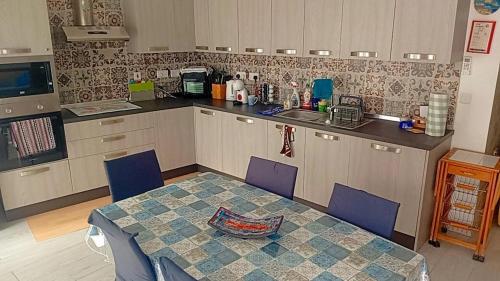 a kitchen with a table and chairs and a counter at D-Onyx Holiday lets Apartment in Żebbuġ