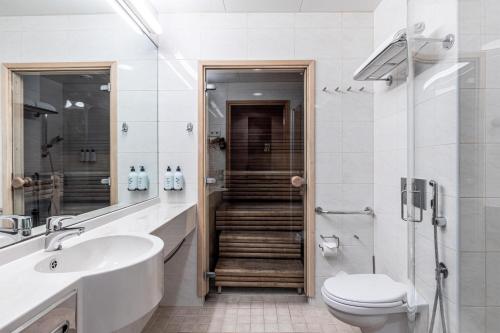 a bathroom with a toilet and a sink and a shower at Scandic Oulu City in Oulu