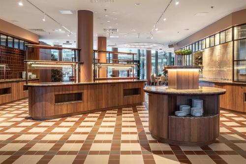 a restaurant with a checkerboard floor at Scandic Oulu City in Oulu