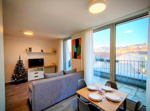 a living room with a couch and a christmas tree at MamaStay Andel Apartments in Prague