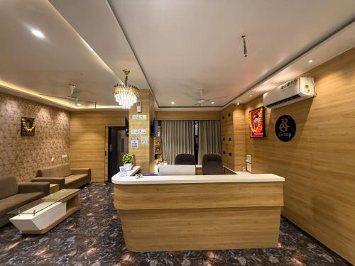 a lobby with a reception desk and a waiting room at Hotel Krish villa in Vadodara