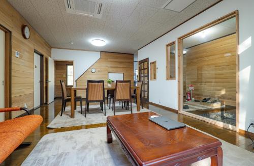 a living room with a table and a dining room at Lake&Mountain Hamamatsu inn in Hamamatsu
