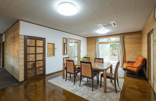 a dining room with a table and chairs at Lake&Mountain Hamamatsu inn in Hamamatsu